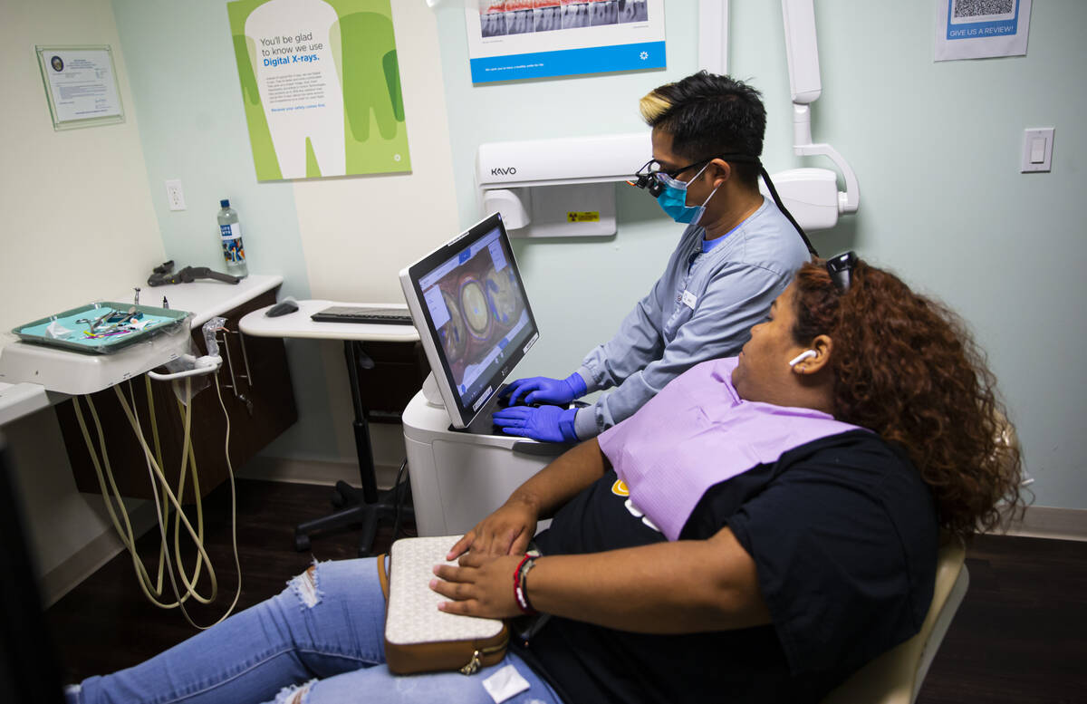 Dental assistant Jason Saavedra works with patient and recent Clark High School graduate Josely ...