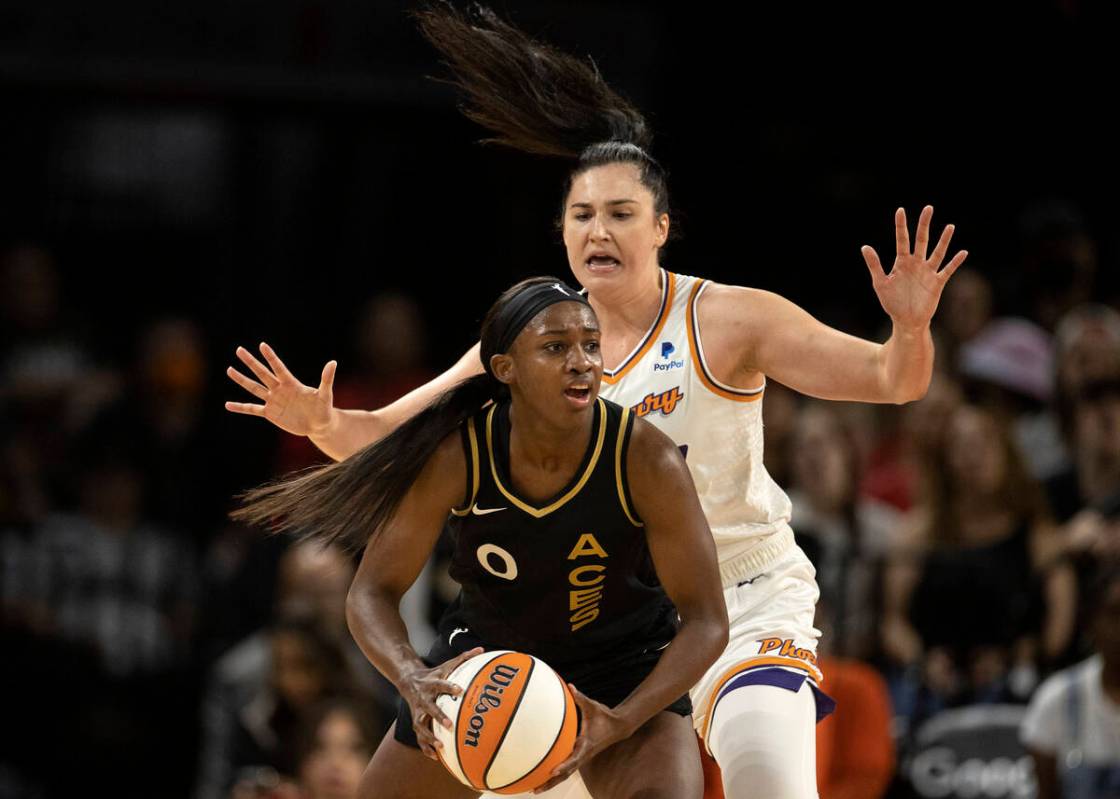 Las Vegas Aces guard Jackie Young (0) looks to pass while Phoenix Mercury center Megan Gustafso ...