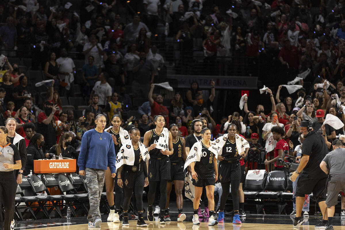 The Las Vegas Aces head to center court after winning a WNBA playoff basketball game against th ...