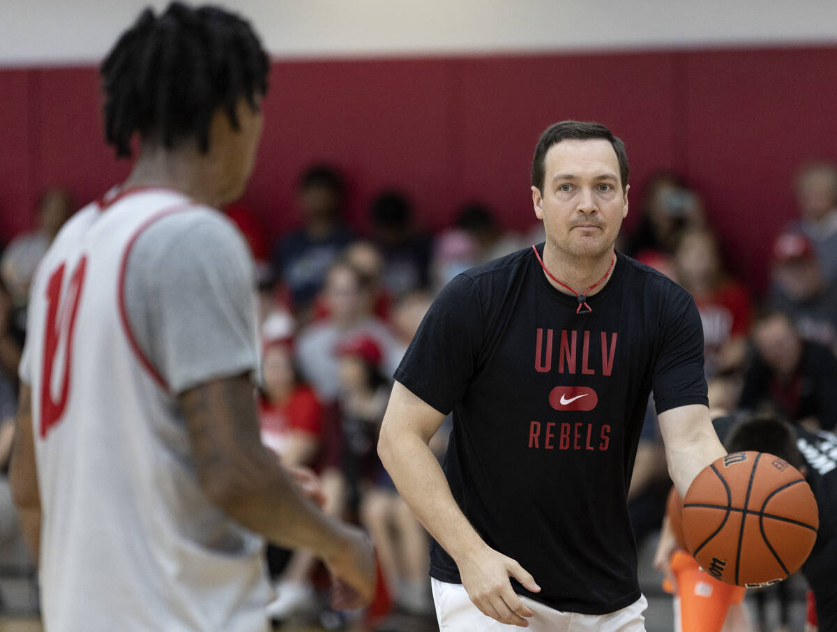 UNLV Rebels head coach Kevin Kruger passes the ball to guard Keshon Gilbert (10) during UNLV me ...