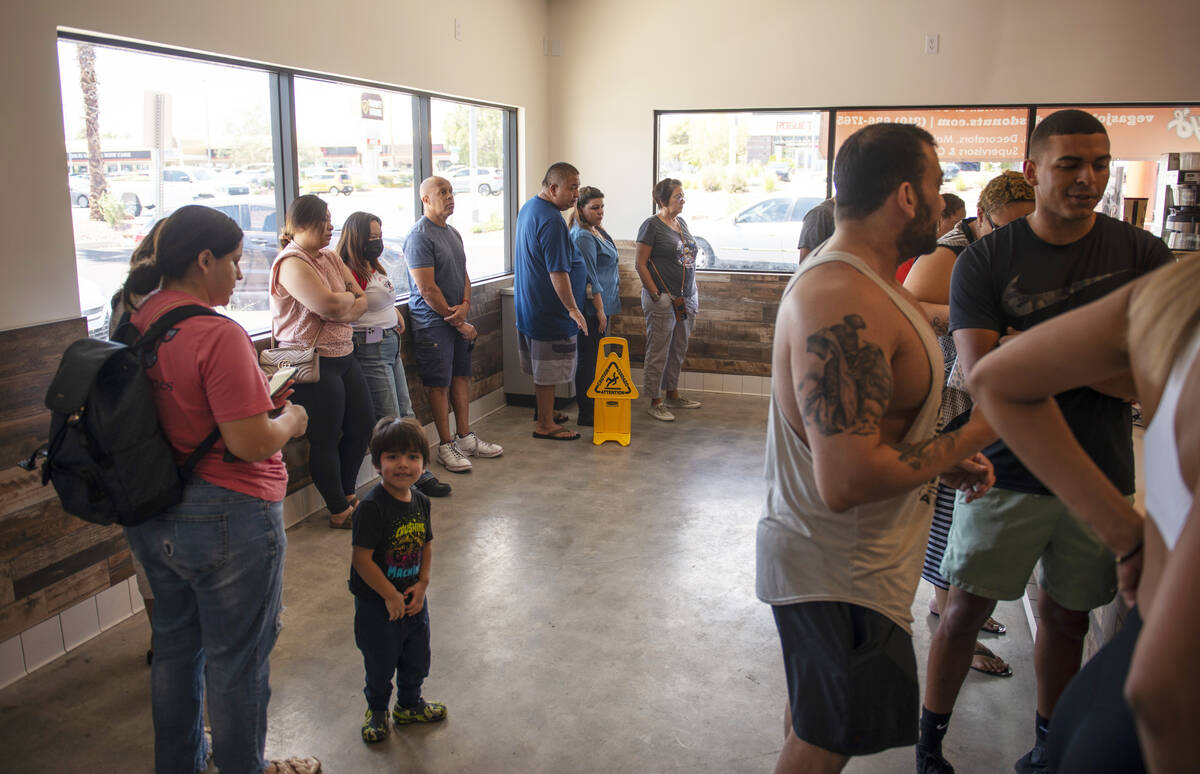 The lines wraps around the store at Randy's Donuts on South Rainbow Boulevard on Friday, Aug. 1 ...