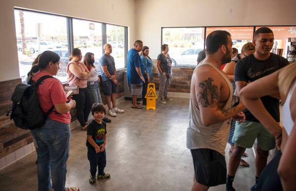 The lines wraps around the store at Randy's Donuts on South Rainbow Boulevard on Friday, Aug. 1 ...