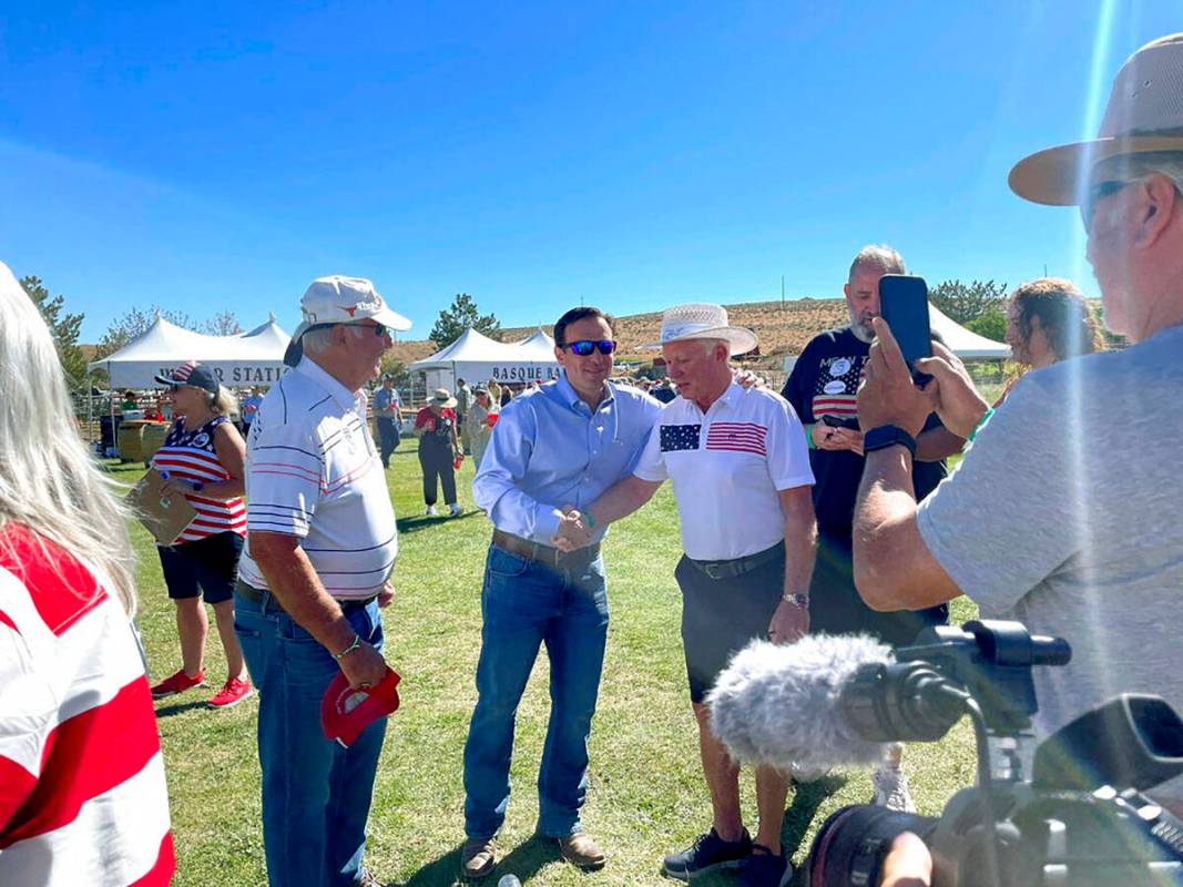Republican U.S. Senate nominee Adam Laxalt, center left, takes pictures with supporters at the ...