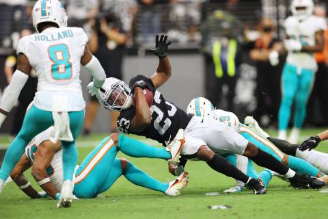 Las Vegas Raiders running back Kenyan Drake (23) is tackled short of the goal line by Miami Dol ...