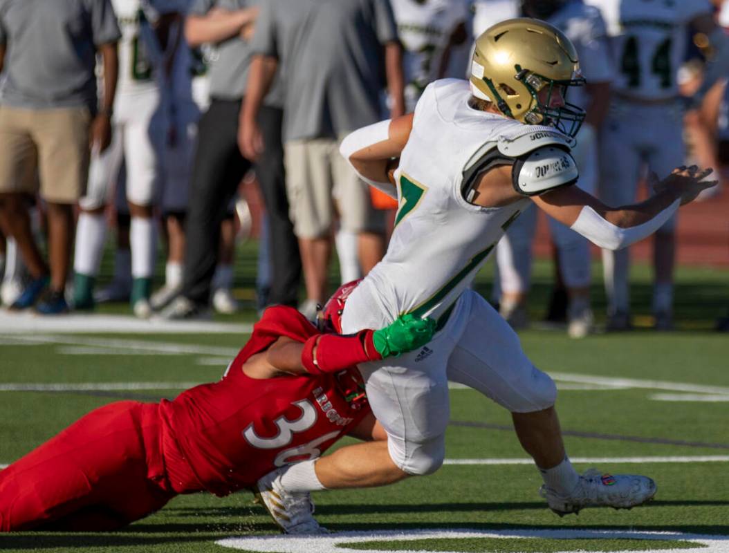 Arbor View High School's Marcus Young (36) tackles Snow Canyon's Hunter Johnson (17) during the ...