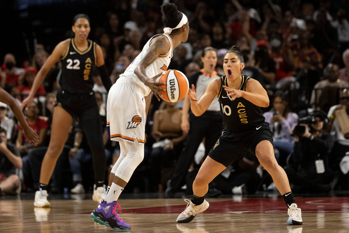 Las Vegas Aces guard Kelsey Plum (10) eggs on Phoenix Mercury guard Yvonne Turner (6) while def ...