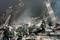 FILE - Firefighters make their way through the rubble after two airliners crashed into the Worl ...