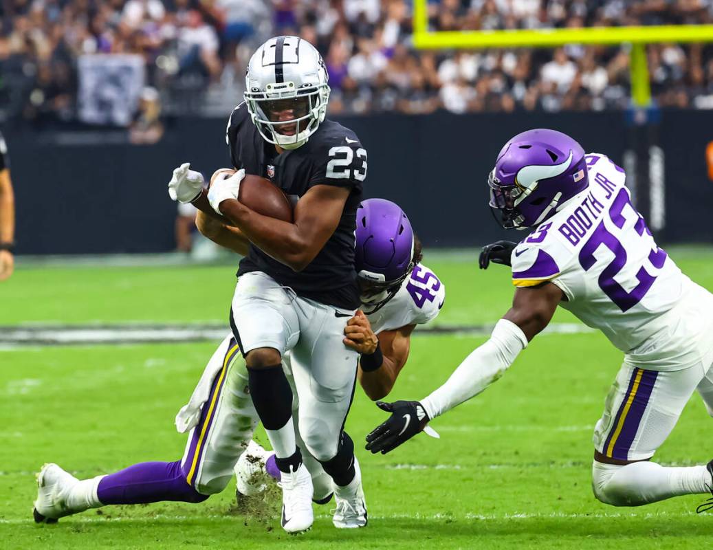 Raiders running back Kenyan Drake (23) runs the ball as Minnesota Vikings linebacker Troy Dye ( ...