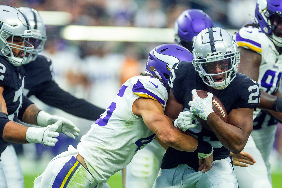 Vikings linebacker Troy Dye (45) wraps up Raiders running back Kenyan Drake (23) near the end z ...