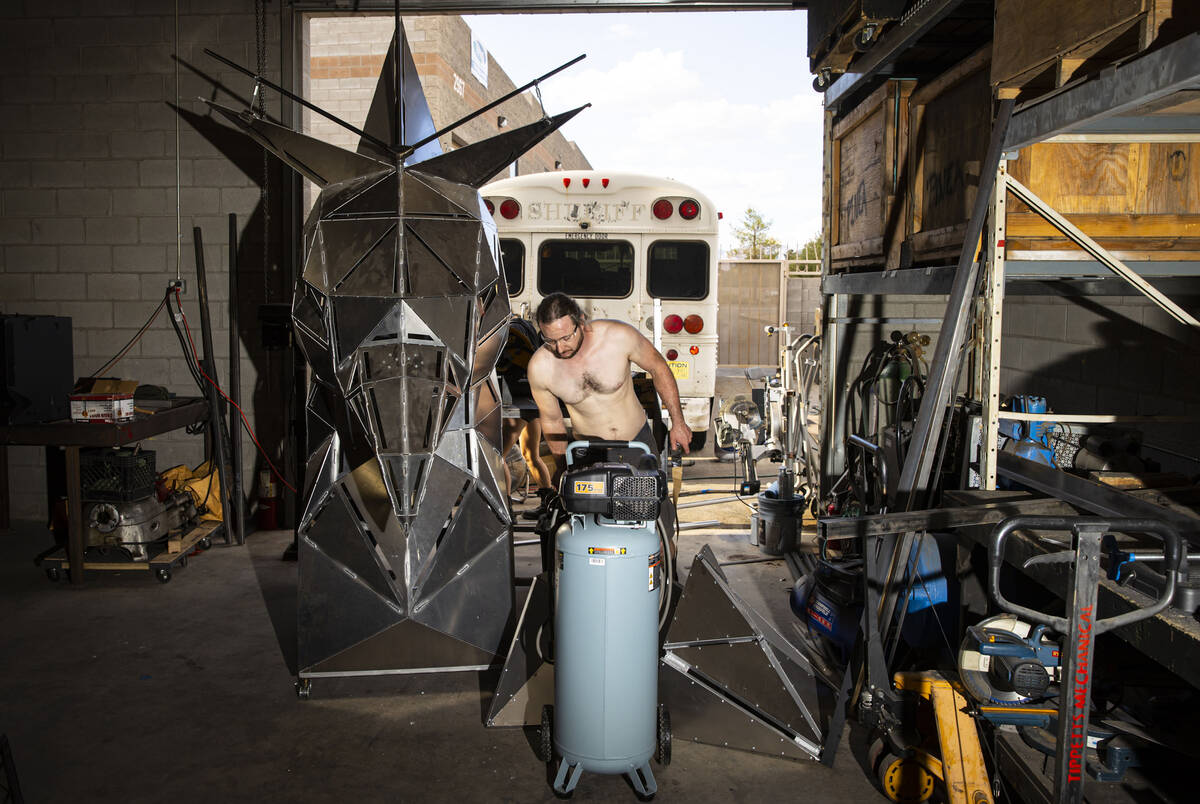 Brad Allen works on the head for The Metaphoenix art car, in preparation for Burning Man, at a ...