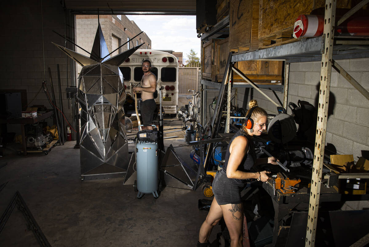 Brad Allen, left, and Mary Fuson, metalworker, work on The Metaphoenix art car, in preparation ...