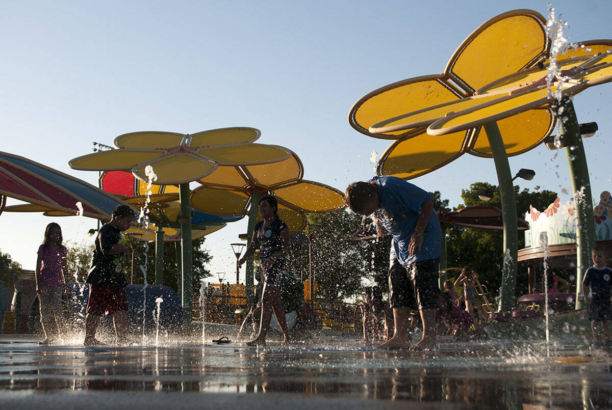 Children play in the splash pad at the Centennial Hills Park in Las Vegas in 2013. (Erik Verduz ...