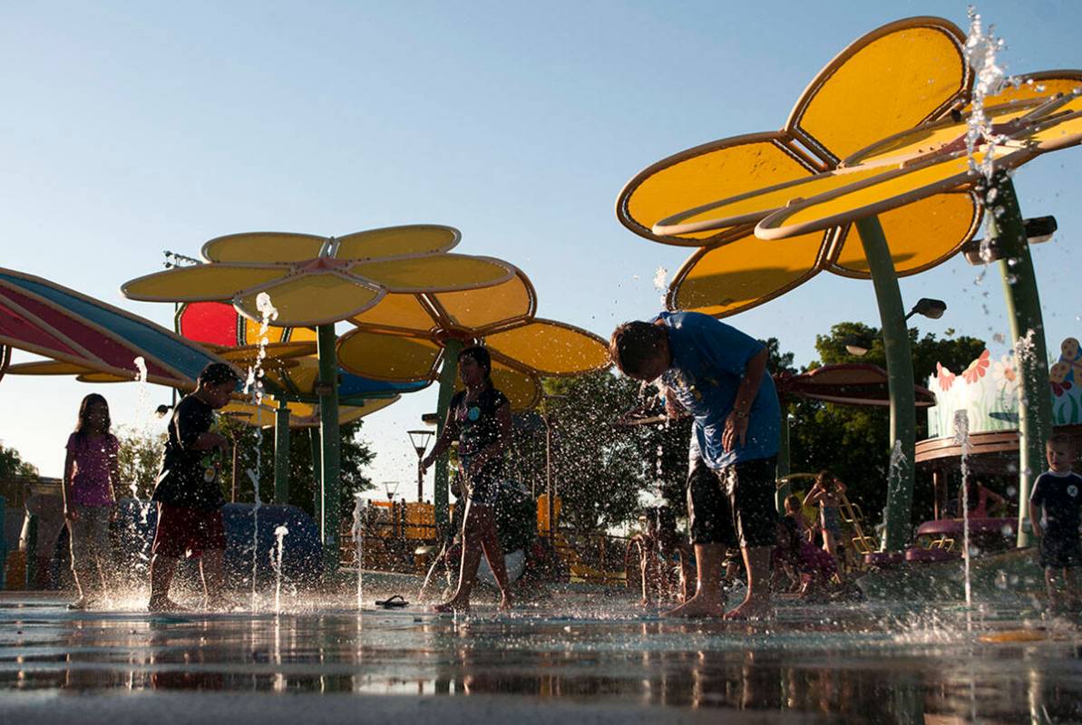 Children play in the splash pad at the Centennial Hills Park in Las Vegas in 2013. (Erik Verduz ...