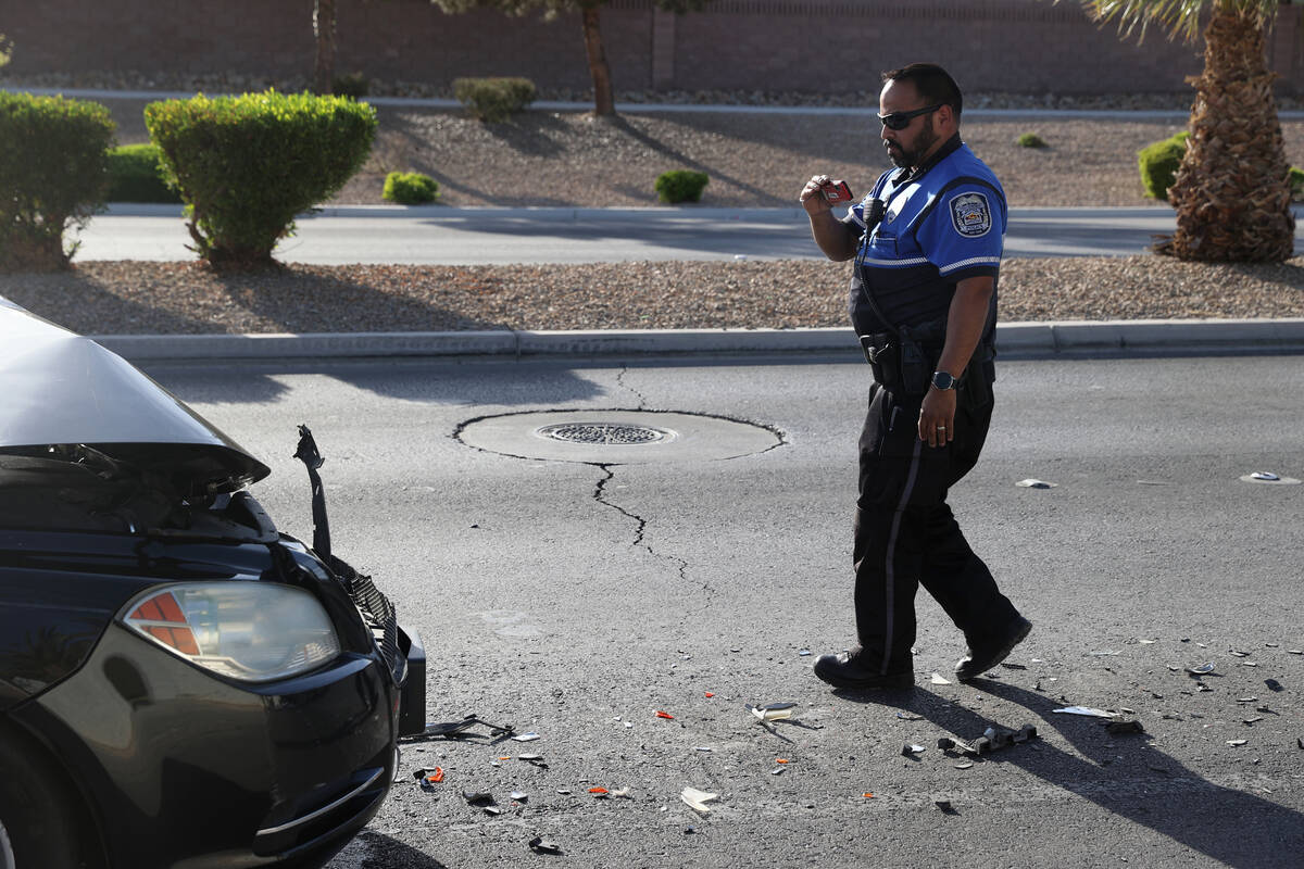 North Las Vegas Police Officer Andy Navarro, a fatal traffic investigator, takes pictures of ev ...