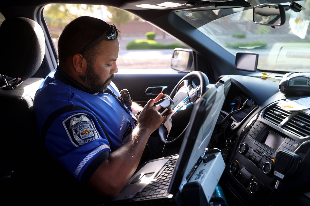 North Las Vegas Police Officer Andy Navarro, a fatal traffic investigator, enters report inform ...