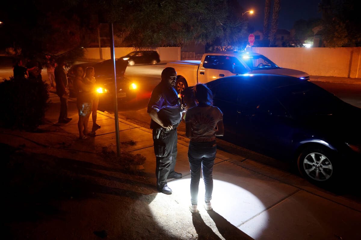North Las Vegas Police Officer Andy Navarro investigates a crash at San Miguel Avenue and Colem ...