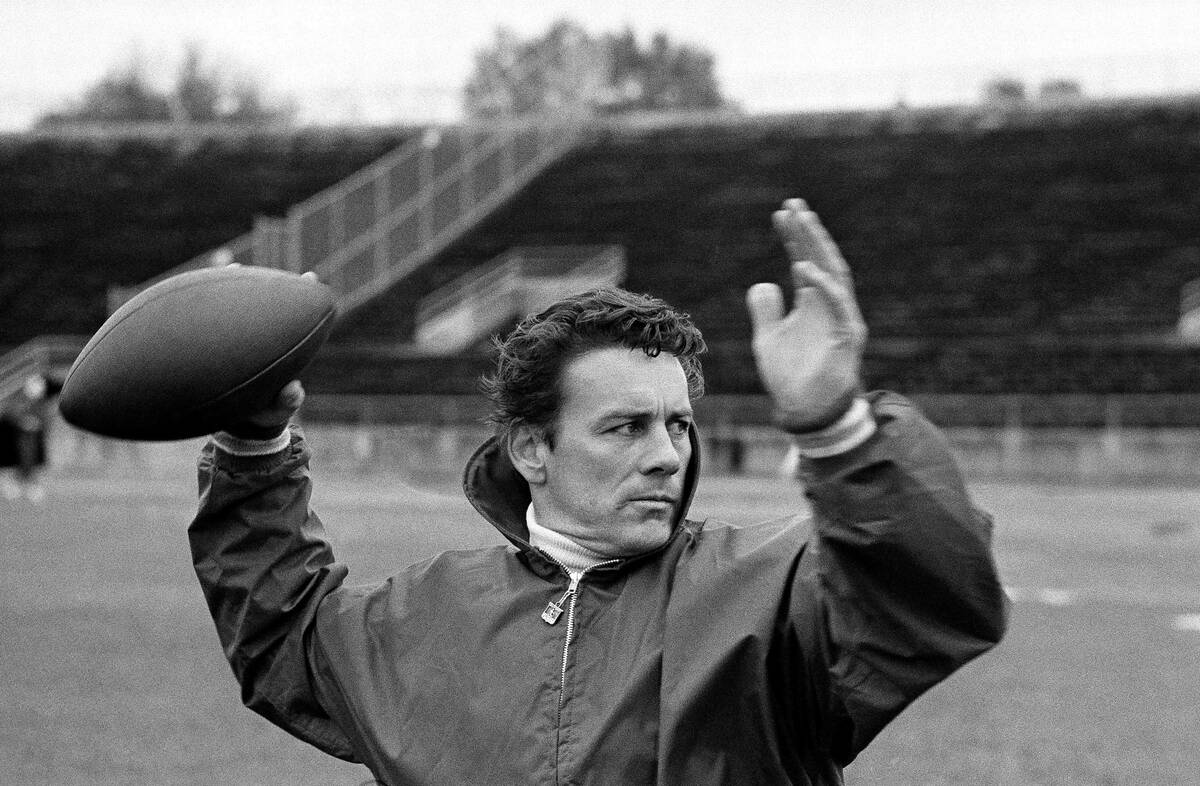 FILE - Len Dawson of the Kansas City Chiefs running through passing drills with receivers in N ...