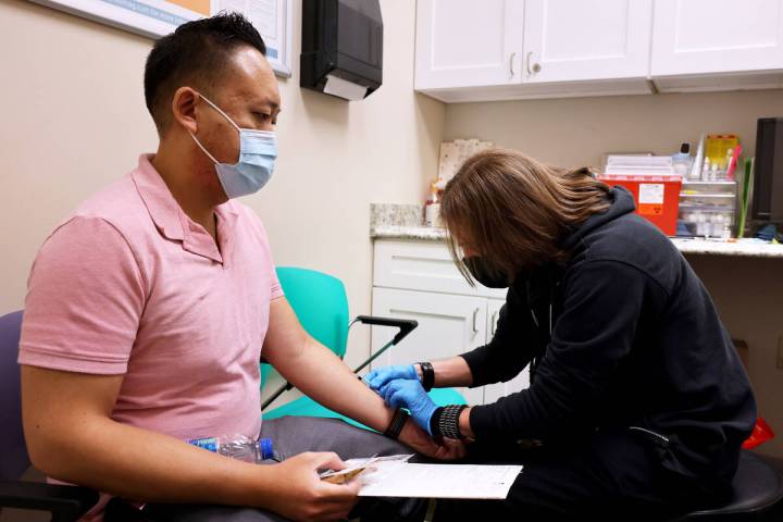 Anoh Ratsamy receives the monkeypox vaccine from registered nurse Christopher Hansen at the Arl ...