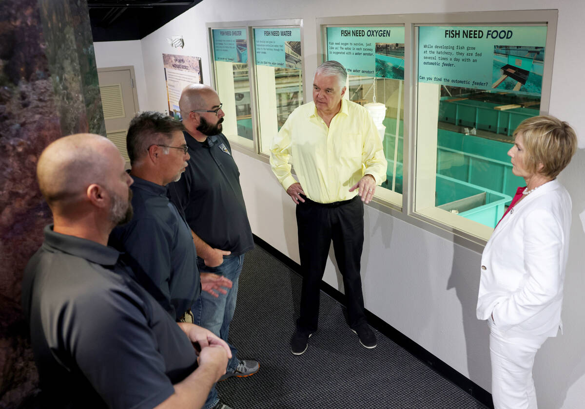 Nevada Gov. Steve Sisolak, second from right, tours the Lake Mead Fish Hatchery with, from left ...