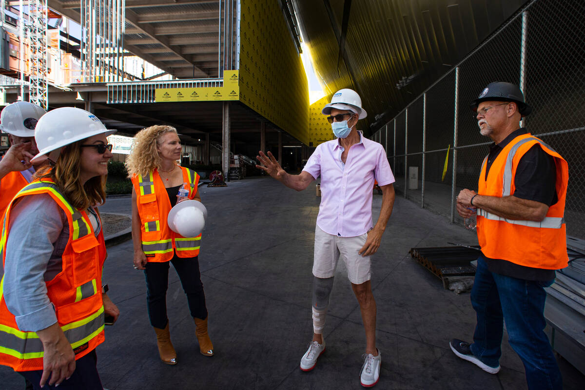 Developer Brett Torino, center right, talks as construction continues at 63, a retail complex b ...