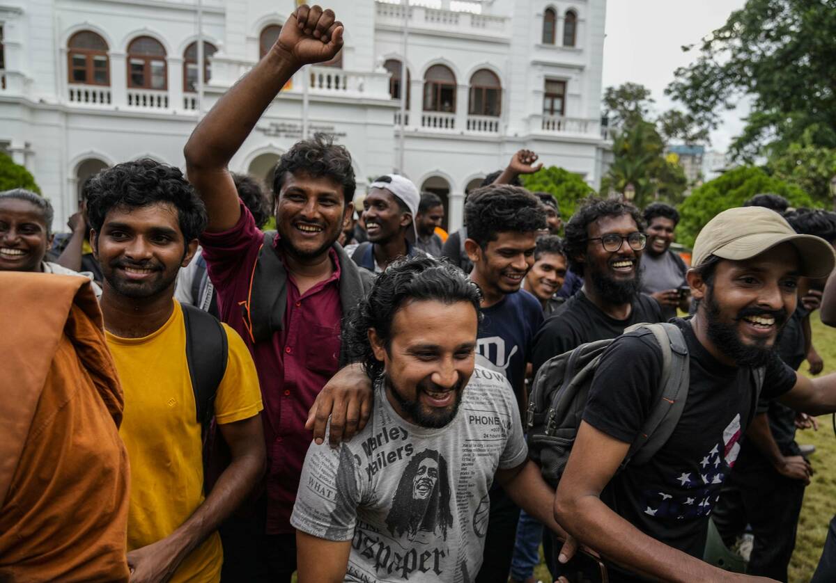 Protesters cheer as they leave prime minister Ranil Wickremesinghe's office building in Colombo ...