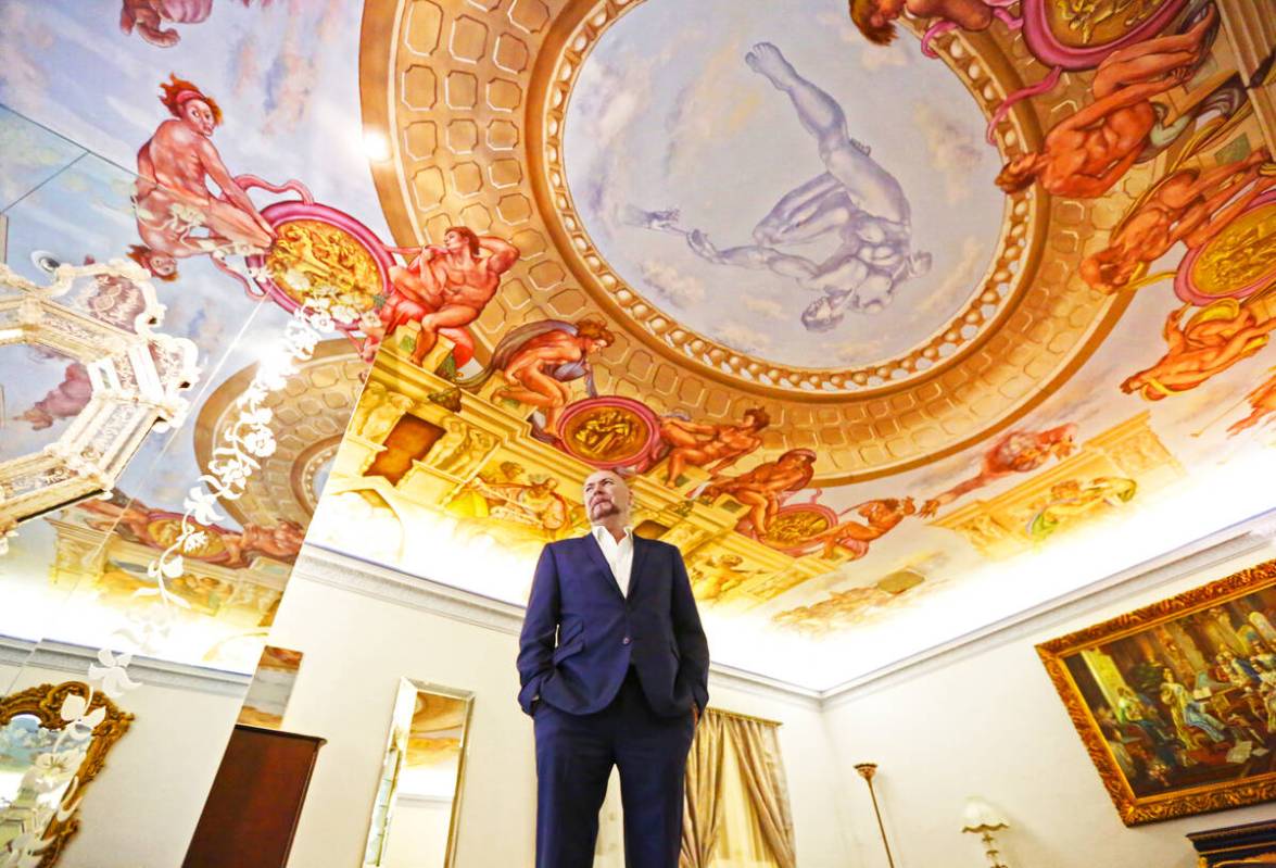 Martyn Ravenhill, owner of the Liberace Mansion, stands in the master bedroom featuring a recre ...