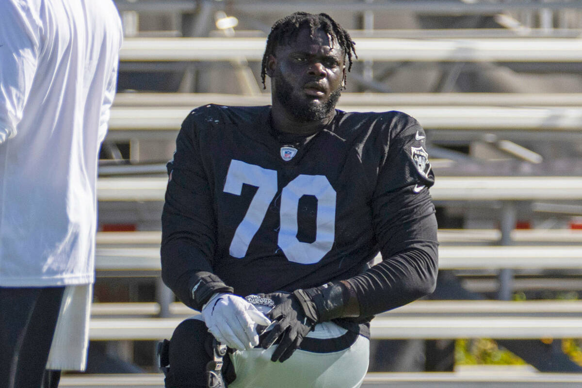 Raiders offensive tackle Alex Leatherwood (70) stretches during the team’s training camp ...