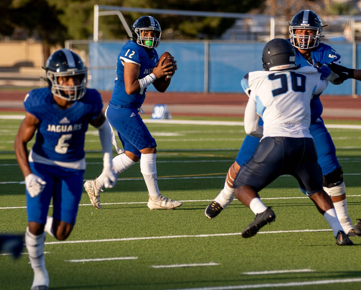 Desert Pines freshman Alex Joseph Stowers (12) looks for a pass in the first half of the game a ...