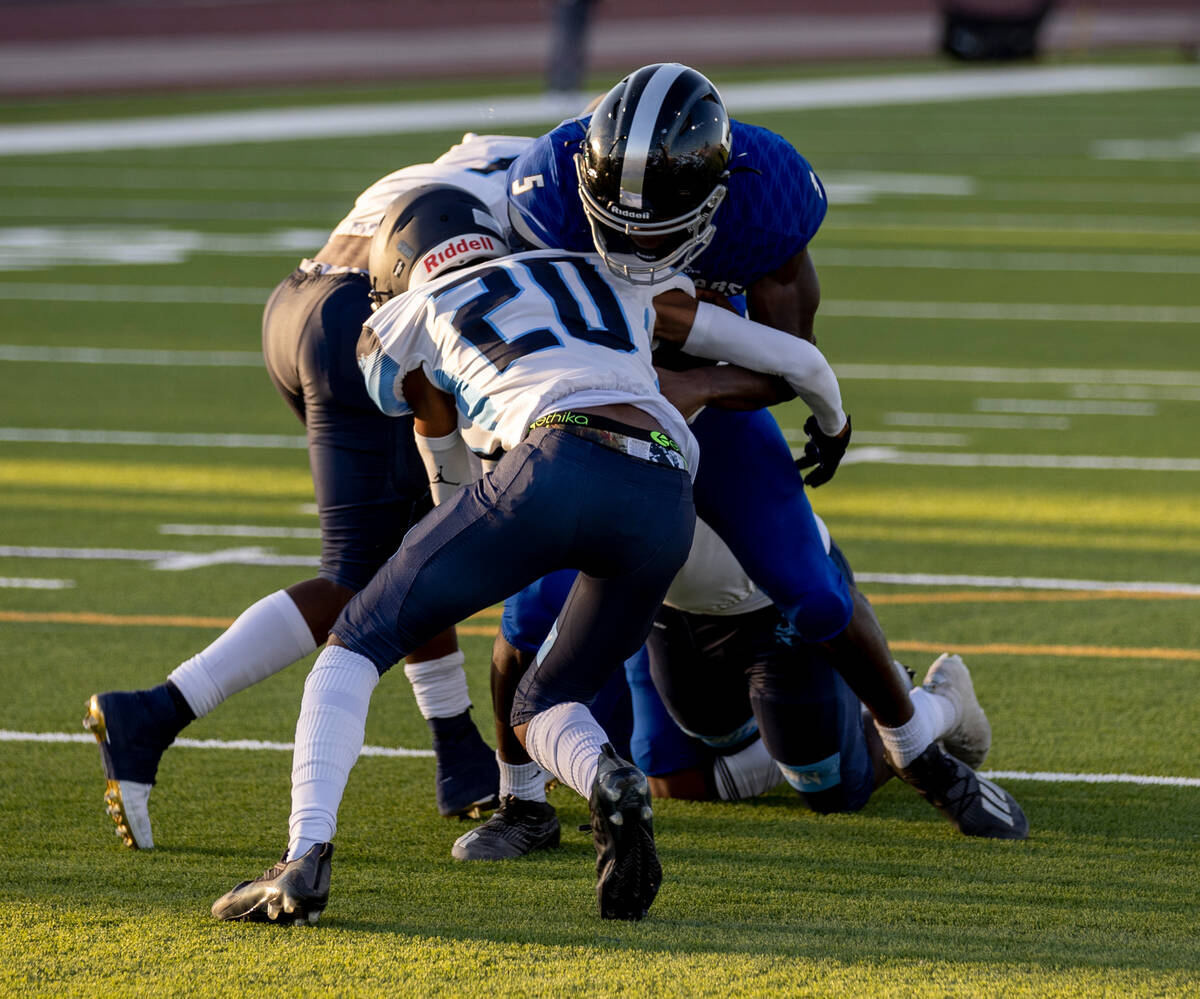 Desert Pines junior Gregory Burrell (5) tries to break through the Canyon Springs defense in th ...