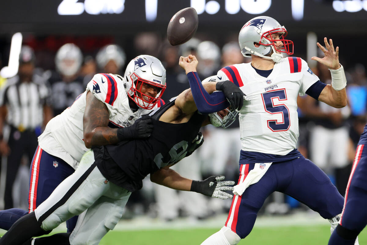 Raiders defensive end Tashawn Bower (96) forces a fumble against New England Patriots quarterba ...