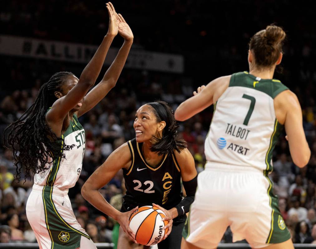 Las Vegas Aces forward A'ja Wilson (22) shoots against Seattle Storm center Ezi Magbegor, left, ...