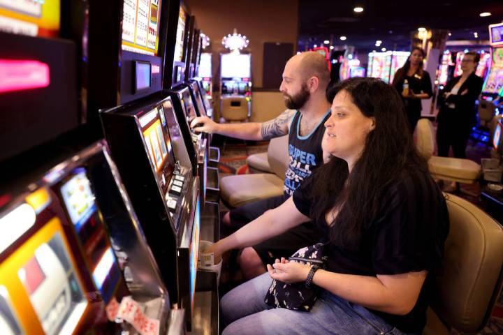 Audra Robison and her husband Neil, of Salt Lake City, play coin slot machines at Circus Circus ...