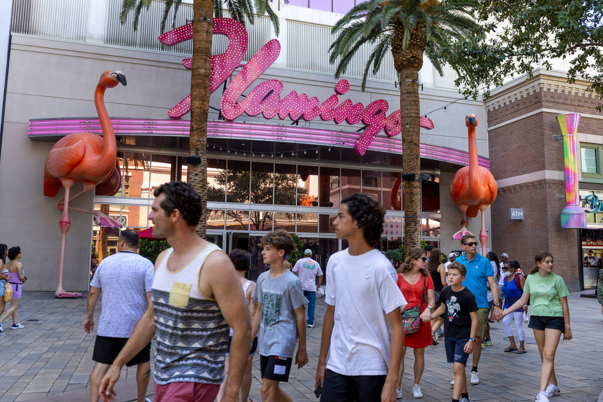 In this July 28, 2022, file photo, visitors walk past the Flamingo entrance. (L.E. Baskow/Las ...