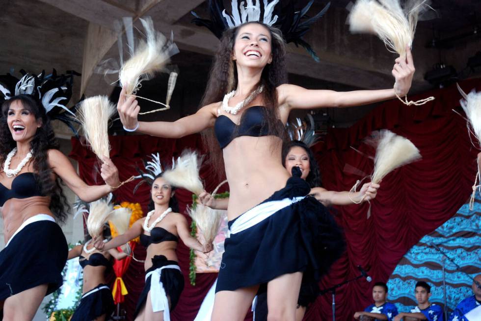 Hawaiian dancers get into the spirt of the annual Prince Kūhiō Ho’olaule&#x2 ...