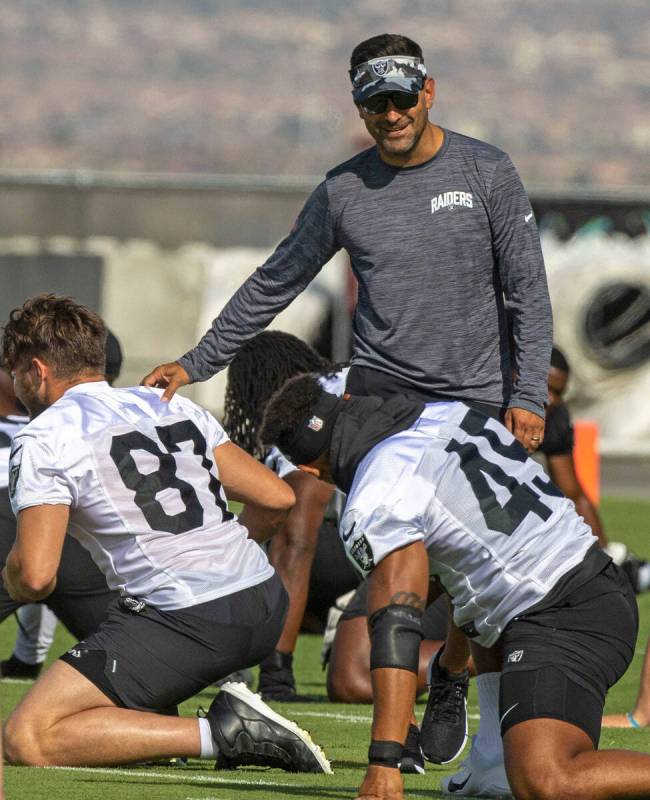 Raiders general manager Dave Ziegler greets tight end Foster Moreau (87) during the team&#x2019 ...