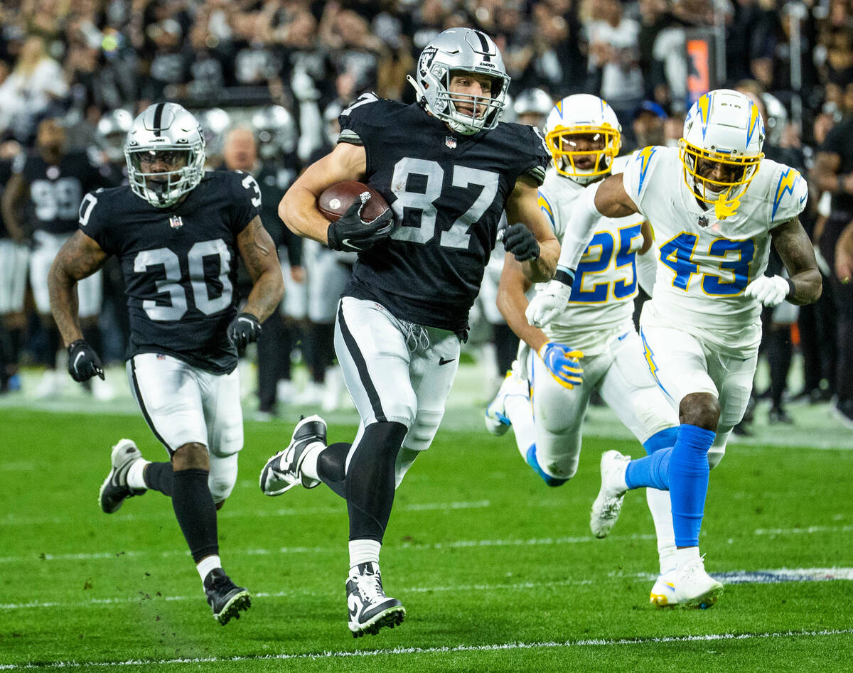 Raiders tight end Foster Moreau (87) rumbles up the field towards the end zone with Los Angeles ...