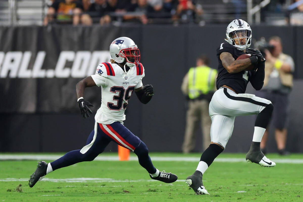 Raiders wide receiver Tyron Johnson (1) makes a catch as New England Patriots cornerback Terran ...