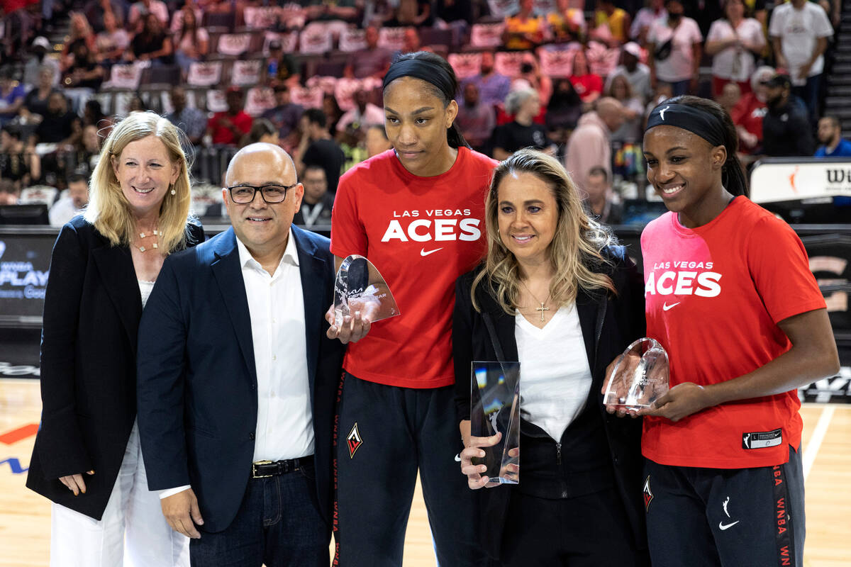 WNBA Commissioner Cathy Engelbert, a representative from Kia, Las Vegas Aces forward A'ja Wilso ...