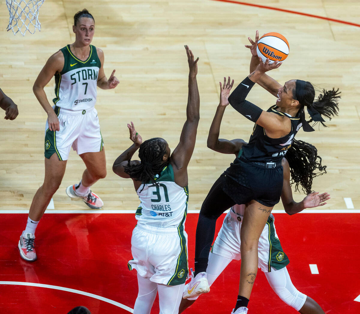 Las Vegas Aces forward A'ja Wilson (22) powers up for a basket over Seattle Storm center Tina C ...