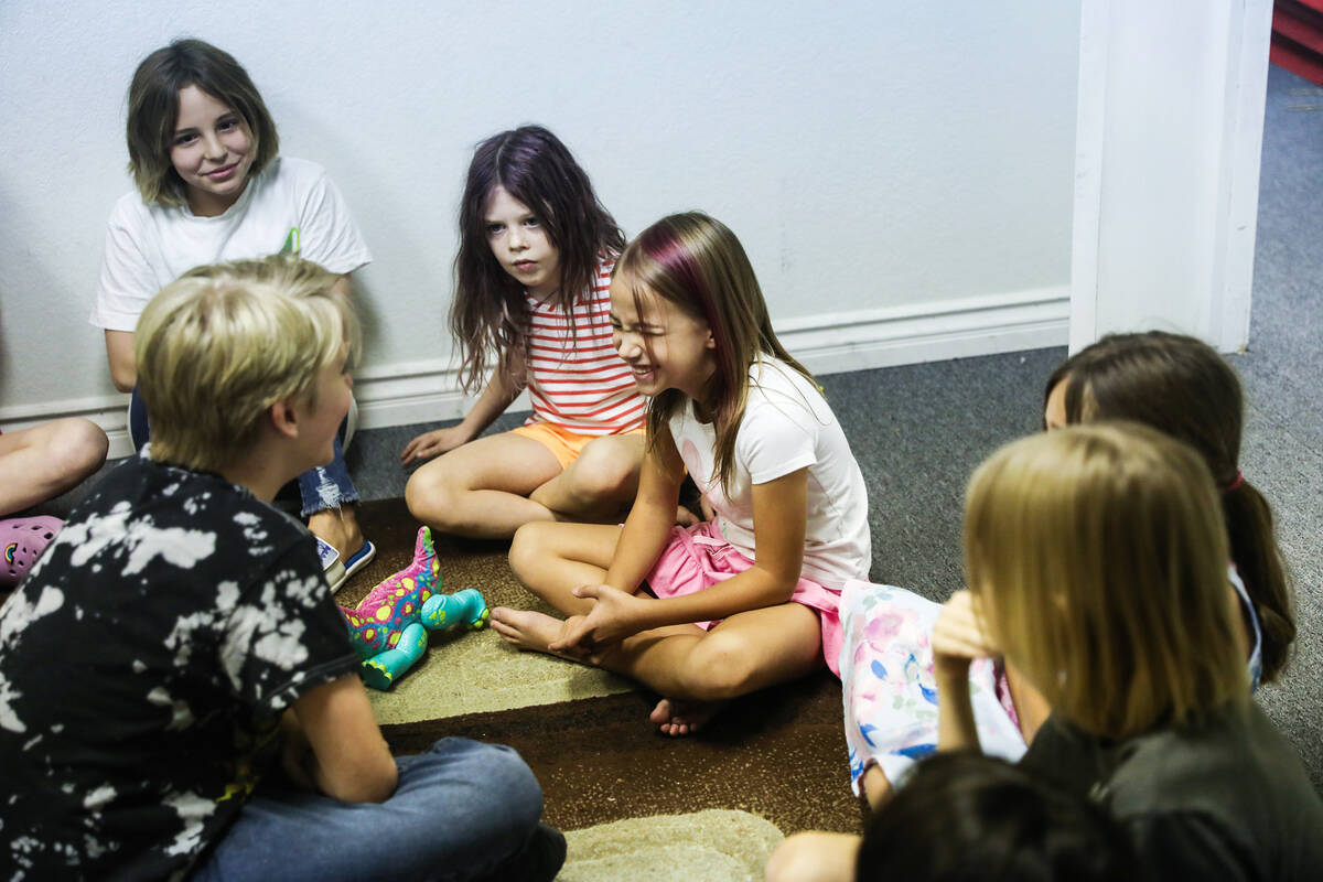 Dan Petit, 12, left, participates in a theater workshop where he made Sunniea Lindskoog, 6, rig ...