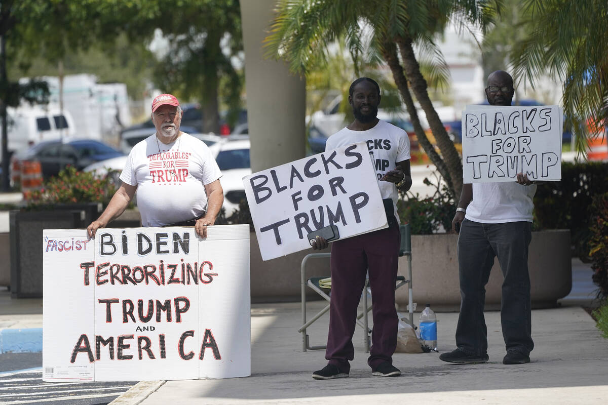 Supporters of former President Donald Trump stand outside the Paul G. Rogers Federal Building a ...