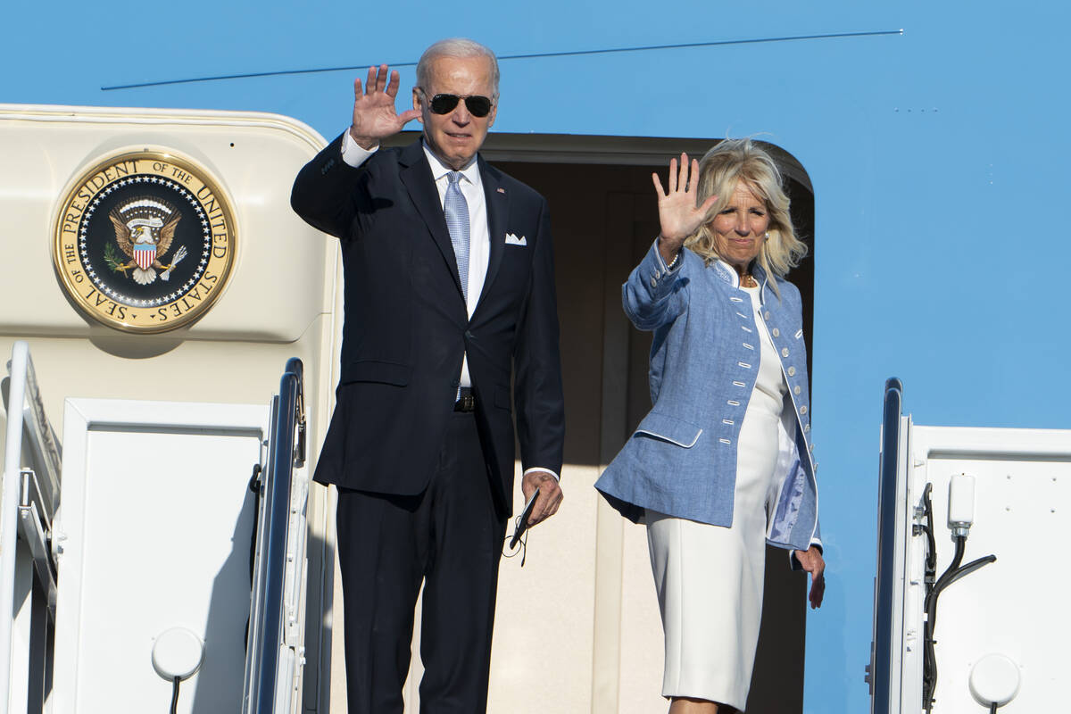 President Joe Biden with first lady Jill Biden wave before boarding Air Force One at Andrews Ai ...