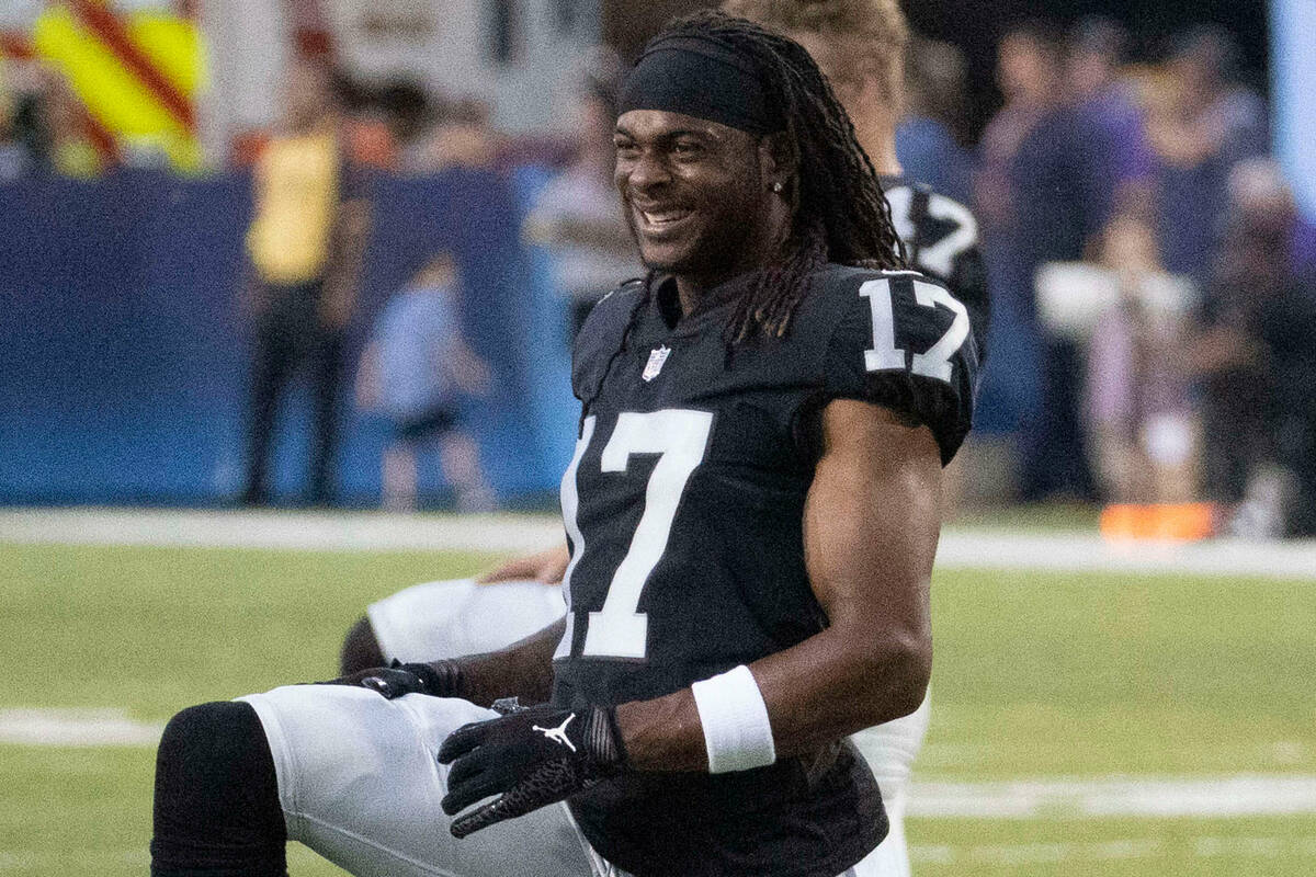 Raiders wide receiver Davante Adams (17) stretches before the NFL Hall of Fame game against the ...