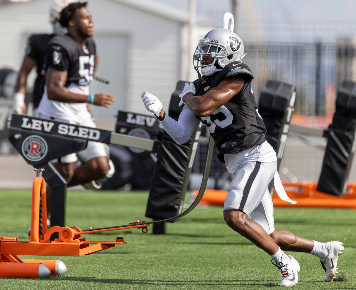 Raiders cornerback Nate Hobbs (39) works the tackle sled during the team’s training camp ...