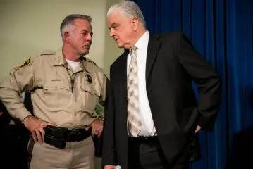 Clark County Sheriff Joe Lombardo, left, and then-County Commissioner Steve Sisolak during a pr ...