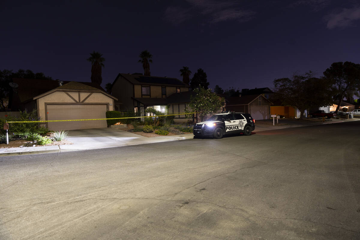 Las Vegas police monitor a homicide scene at the 7200 block of Bronze Circle in Las Vegas, Satu ...