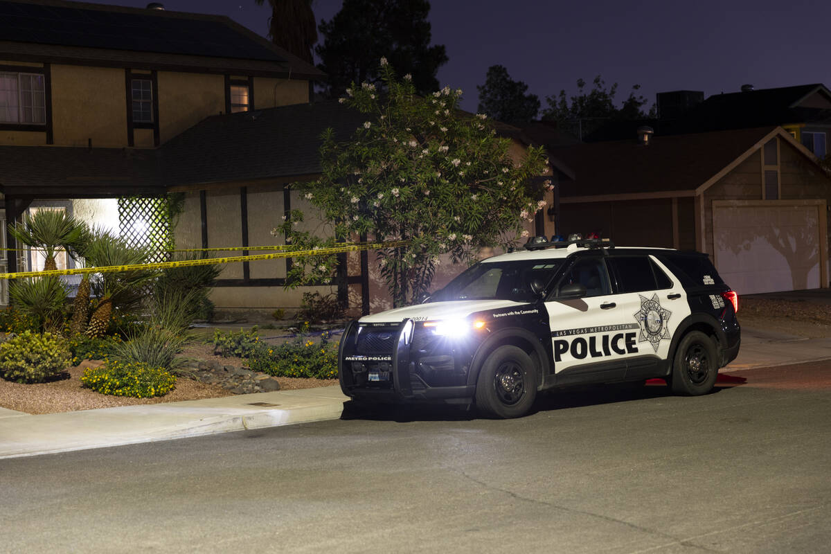 Las Vegas police monitor a homicide scene at the 7200 block of Bronze Circle in Las Vegas, Satu ...