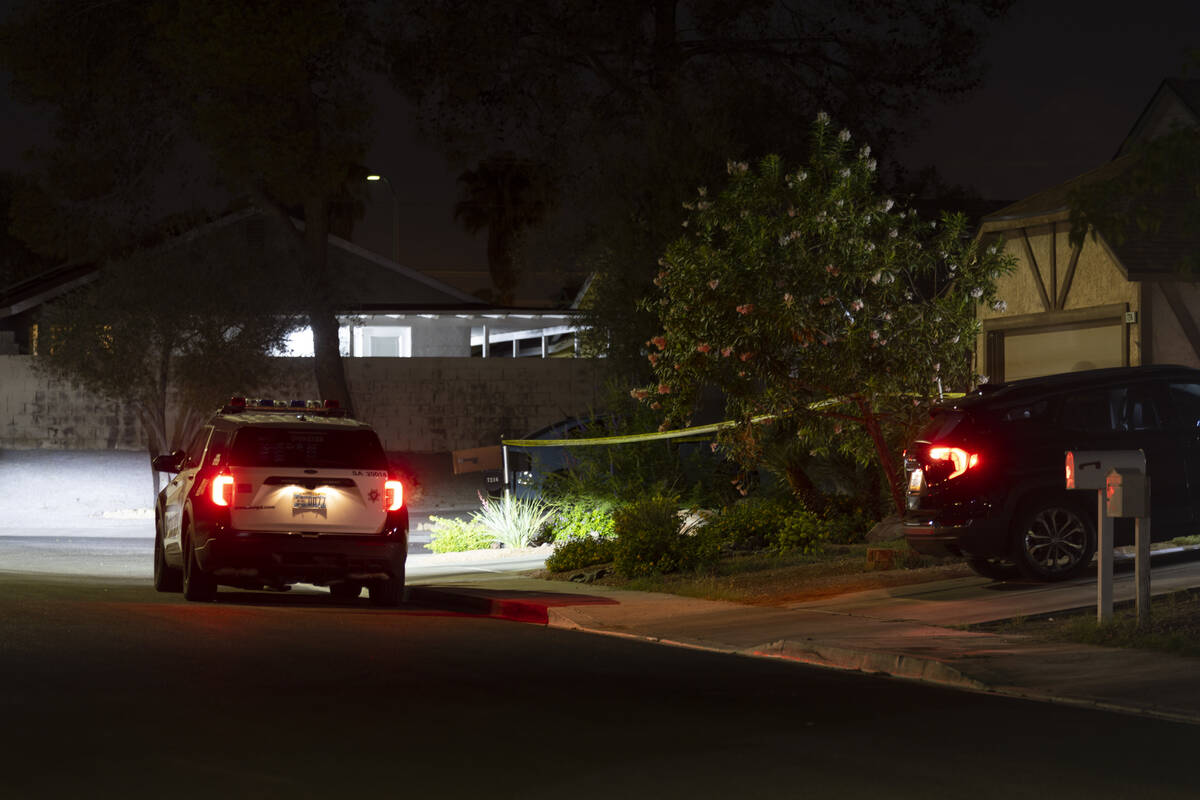 Las Vegas police monitor a homicide scene at the 7200 block of Bronze Circle in Las Vegas, Satu ...