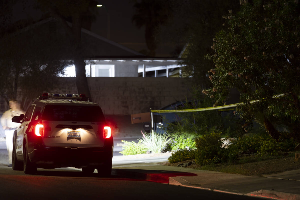 Las Vegas police monitor a homicide scene at the 7200 block of Bronze Circle in Las Vegas, Satu ...