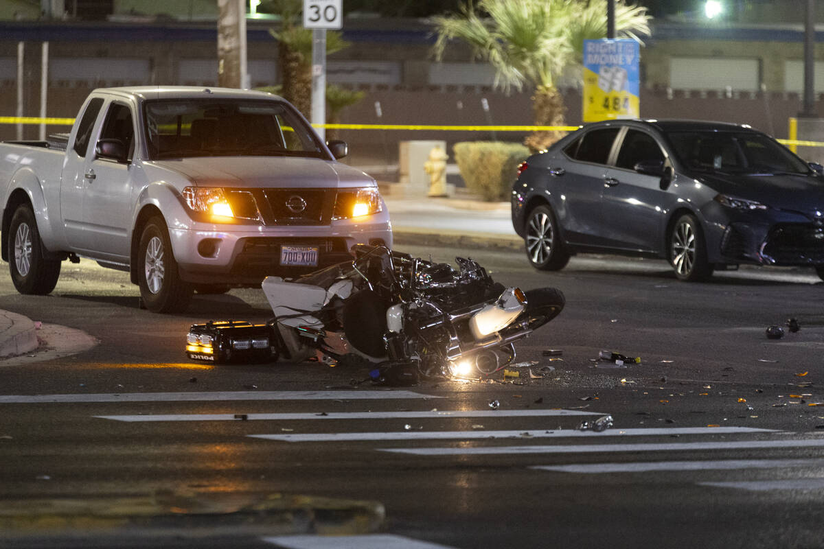 Las Vegas police investigate the scene of an accident involving a police motorcycle officer at ...